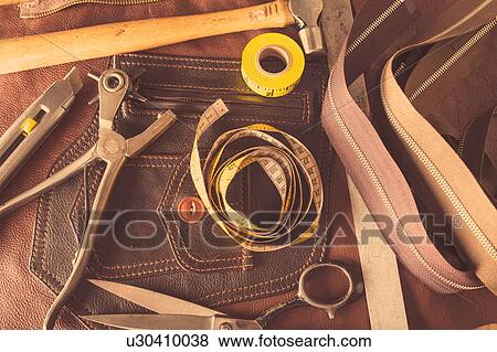 Stock Photo - Still life of dressmaking equipment in leather jacket manufacturers, close-up. Fotosearch