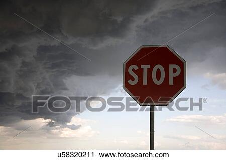 Stock Image - Stop sign on dark cloudy day. Fotosearch