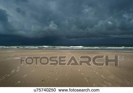 Storm clouds over beach and North sea, Nes, Friesland, Netherlands View Large Photo Image Stock Image - Storm clouds over beach and North sea, Nes, Friesland, Netherlands. Fotosearch