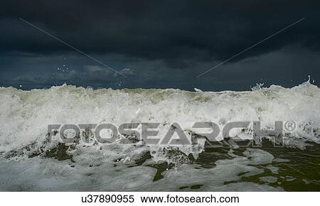 Stock Photography - Stormy sky and crashing ocean waves, Domburg, Zeeland, Netherlands. Fotosearch