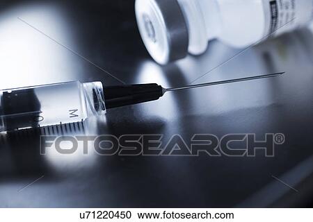 Stock Image - Studio shot of syringe and vial. Fotosearch