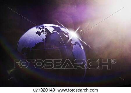 Stock Photo - Sun shining over globe. Fotosearch