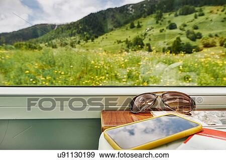 Sunglasses and smartphone by passenger train window, Chur, Switzerland View Large Photo Image Stock Photo - Sunglasses and smartphone by passenger train window, Chur, Switzerland. Fotosearch