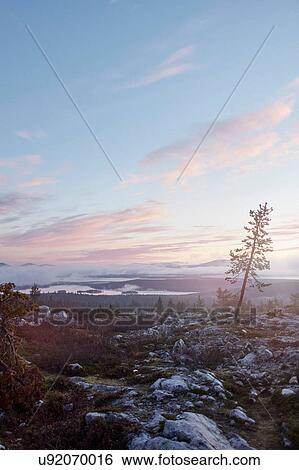 Stock Photograph - Sunset over landscape, Sarkitunturi, Lapland, Finland. Fotosearch