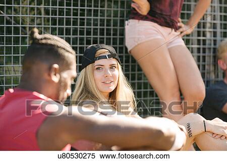 Three adult friends sitting chatting on basketball court View Large Photo Image Stock Photography - Three adult friends sitting chatting on basketball court. Fotosearch