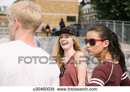 Three male and female friends laughing in city skatepark View Large Photo Image Stock Photography - Three male and female friends laughing in city skatepark. Fotosearch