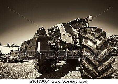 Tractor with wheel in foreground View Large Photo Image Picture - Tractor with wheel in foreground. Fotosearch