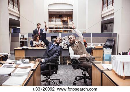 Two businessmen high-fiving in office View Large Photo Image Stock Image - Two businessmen high-fiving in office. Fotosearch