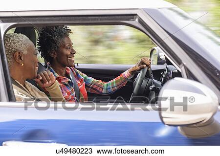 Stock Image - Two smiling women in car. Fotosearch