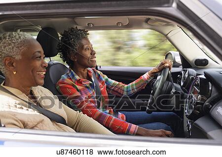 Stock Photo - Two smiling women in car. Fotosearch