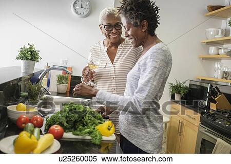 Two women cooking in domestic kitchen View Large Photo Image Stock Photography - Two women cooking in domestic kitchen. Fotosearch