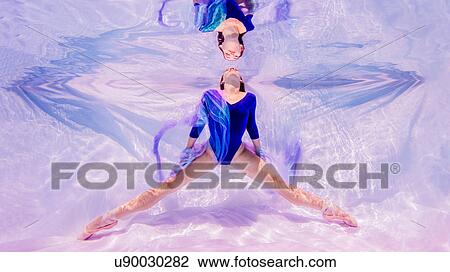 Underwater view of girl wearing blue leotard and ballet shoes, facing surface of water View Large Photo Image Stock Image - Underwater view of girl wearing blue leotard and ballet shoes, facing surface of water. Fotosearch