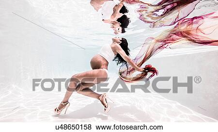 Underwater view of pregnant woman, face towards surface of water View Large Photo Image Stock Photo - Underwater view of pregnant woman, face towards surface of water. Fotosearch