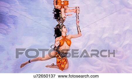 Underwater view of woman, partially clothed, hand breaking water surface View Large Photo Image Stock Photo - Underwater view of woman, partially clothed, hand breaking water surface. Fotosearch