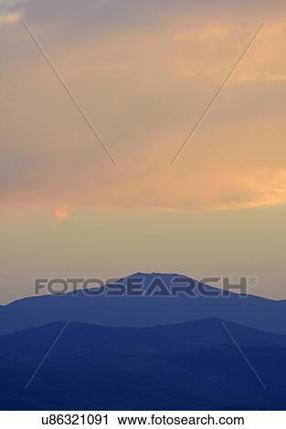 Stock Image - USA, Colorado, Denver, Moody sky over mountain range. Fotosearch