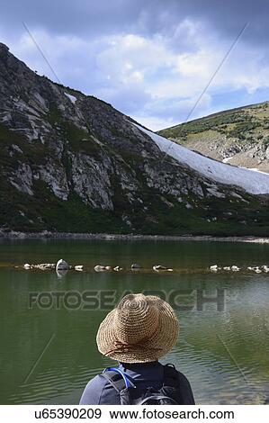 USA, Colorado, Idaho Springs, Hiker sitting by lake below Saint Mary's Glacier View Large Photo Image Stock Photo - USA, Colorado, Idaho Springs, Hiker sitting by lake below Saint Mary's Glacier. Fotosearch
