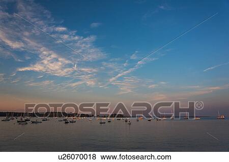 Stock Photo - USA, Maine, Camden, Sailboats at sunset. Fotosearch