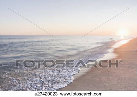 Stock Image - USA, Massachusetts, Nantucket, Cisco Beach, Sunset over sea. Fotosearch