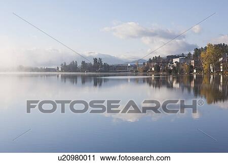Stock Image - USA, New York, Lake Placid Village, Mirror Lake. Fotosearch