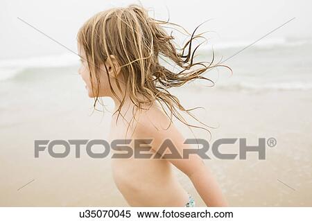 Stock Photography - USA, New York, Monatuk, Girl (2-3) running on beach by ocean. Fotosearch