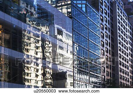 Stock Image - USA, New York, New York City, Glass facade of office building. Fotosearch