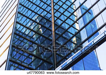 Stock Image - USA, New York, New York City, Glass facade of office building. Fotosearch