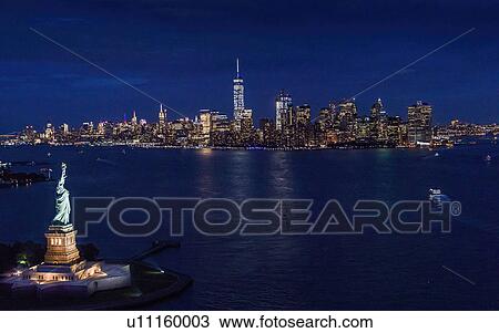 USA, New York, New York City, Manhattan, Aerial view of illuminated skyline with Statue of Liberty at night View Large Photo Image Stock Image - USA, New York, New York City, Manhattan, Aerial view of illuminated skyline with Statue of Liberty at night. Fotosearch