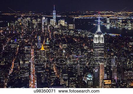 USA, New York, New York City, Manhattan, Aerial view of illuminated skyline at night View Large Photo Image Stock Image - USA, New York, New York City, Manhattan, Aerial view of illuminated skyline at night. Fotosearch