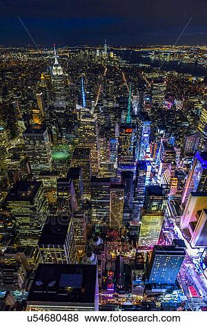 Stock Photo - USA, New York, New York City, Manhattan, Aerial view of illuminated skyline with Times Square at night. Fotosearch