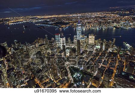 USA, New York, New York City, Manhattan, Aerial view of illuminated skyline with harbor at night View Large Photo Image Stock Photography - USA, New York, New York City, Manhattan, Aerial view of illuminated skyline with harbor at night. Fotosearch