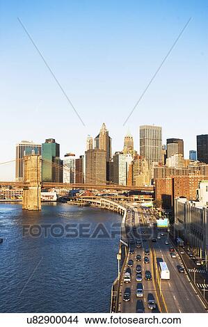 Picture - USA, New York State, New York City, Manhattan, Franklin D. Roosevelt East River Drive and Brooklyn Bridge at sunset. Fotosearch