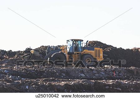 USA, New York State, New York City, Bulldozer on garbage dump View Large Photo Image Stock Image - USA, New York State, New York City, Bulldozer on garbage dump. Fotosearch