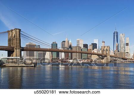Stock Image - USA, New York State, New York City, Manhattan, City panorama with Brooklyn Bridge. Fotosearch