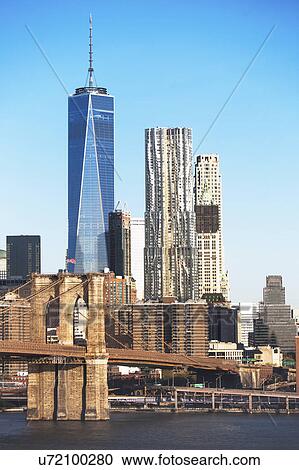 Stock Image - USA, New York State, New York City, Manhattan, City panorama with Brooklyn Bridge. Fotosearch