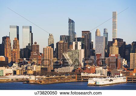 Stock Image - USA, New York State, New York City, City panorama seen across Hudson River. Fotosearch