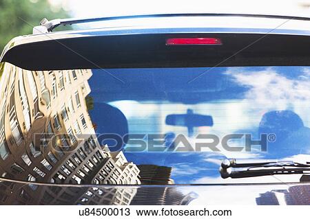 Stock Image - USA, New York State, New York City, City street reflecting in car rear window. Fotosearch