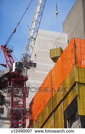 Stock Photo - USA, New York State, New York City, Manhattan, Crane at construction site. Fotosearch