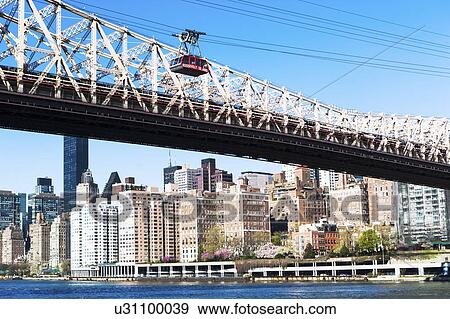 Stock Photo - USA, New York State, New York City, Manhattan, City panorama with Queensboro Bridge over East River in foreground. Fotosearch