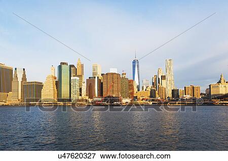 Stock Photo - USA, New York State, New York City, Manhattan, City panorama seen across East River. Fotosearch