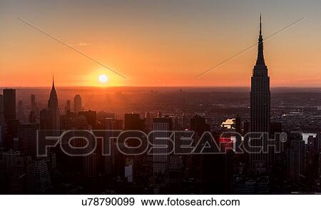 USA, New York State, New York City, Office buildings at sunrise View Large Photo Image Stock Photo - USA, New York State, New York City, Office buildings at sunrise. Fotosearch