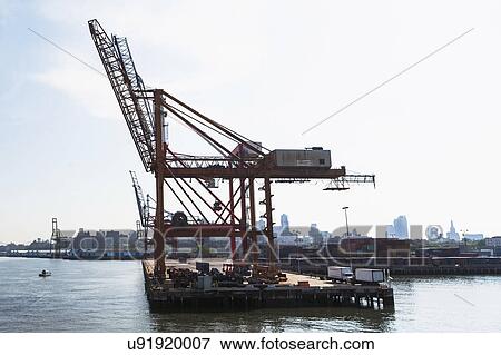 USA, New York State, New York City, Commercial dock and city skyline in background View Large Photo Image Stock Photo - USA, New York State, New York City, Commercial dock and city skyline in background. Fotosearch