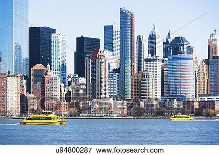 USA, New York State, New York City, Manhattan, City panorama with water taxis passing by View Large Photo Image Stock Photo - USA, New York State, New York City, Manhattan, City panorama with water taxis passing by. Fotosearch