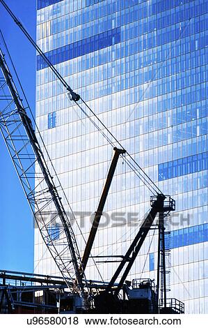 Stock Photo - USA, New York State, New York City, Manhattan, Detail of crane and office building. Fotosearch