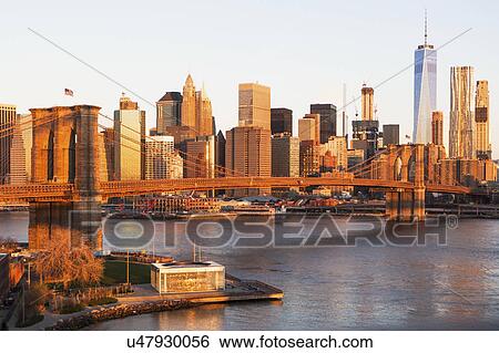 Stock Photograph - USA, New York State, New York City, Brooklyn Bridge and Manhattan at dawn. Fotosearch