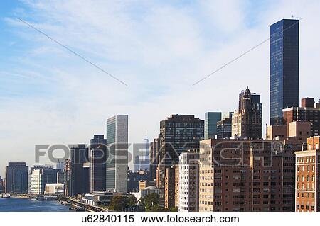 Stock Photography - USA, New York State, New York City, Manhattan, City with cloudy sky. Fotosearch