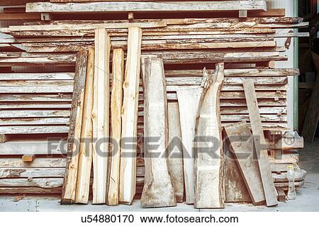 Stock Image - Variety of cut wood and logs. Fotosearch