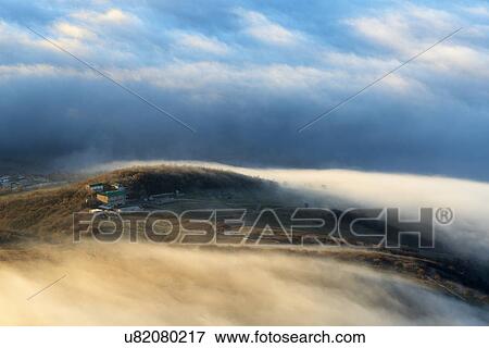 Stock Photo - View of dispersing mountain mist from Luchistoye Village, South Demergi mountain, Crimea, Ukraine. Fotosearch
