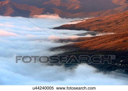 Stock Photography - View of mountain valley mist from South Demergi mountain, Crimea, Ukraine. Fotosearch
