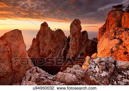 Stock Image - View of rock formations at sunset from Ai-Petri Mountain, Crimea, Ukraine. Fotosearch