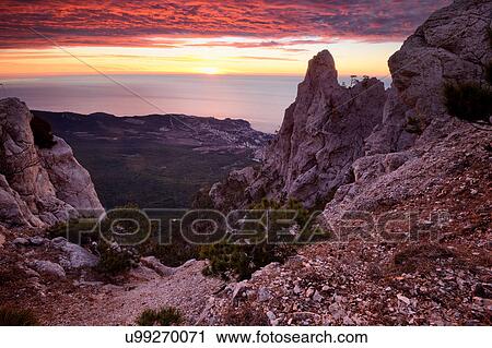 Stock Image - View of rock formations at sunset from Ai-Petri Mountain, Crimea, Ukraine. Fotosearch